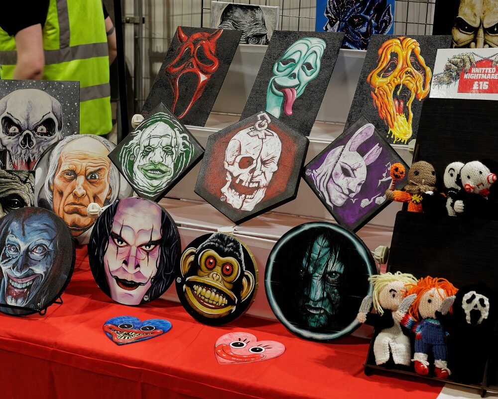table full of horror art - Horror Con Scotland Table full of horror art